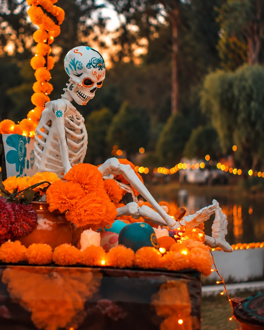 Skeleton figure among marigolds at dusk